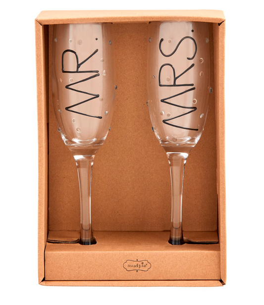 Two champagne flutes with 'MR' and 'MRS' text in a cardboard box, brand 'mutlipie' visible.